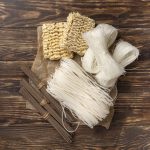 flat-lay-uncooked-assortment-noodles-wooden-background_23-2148377401